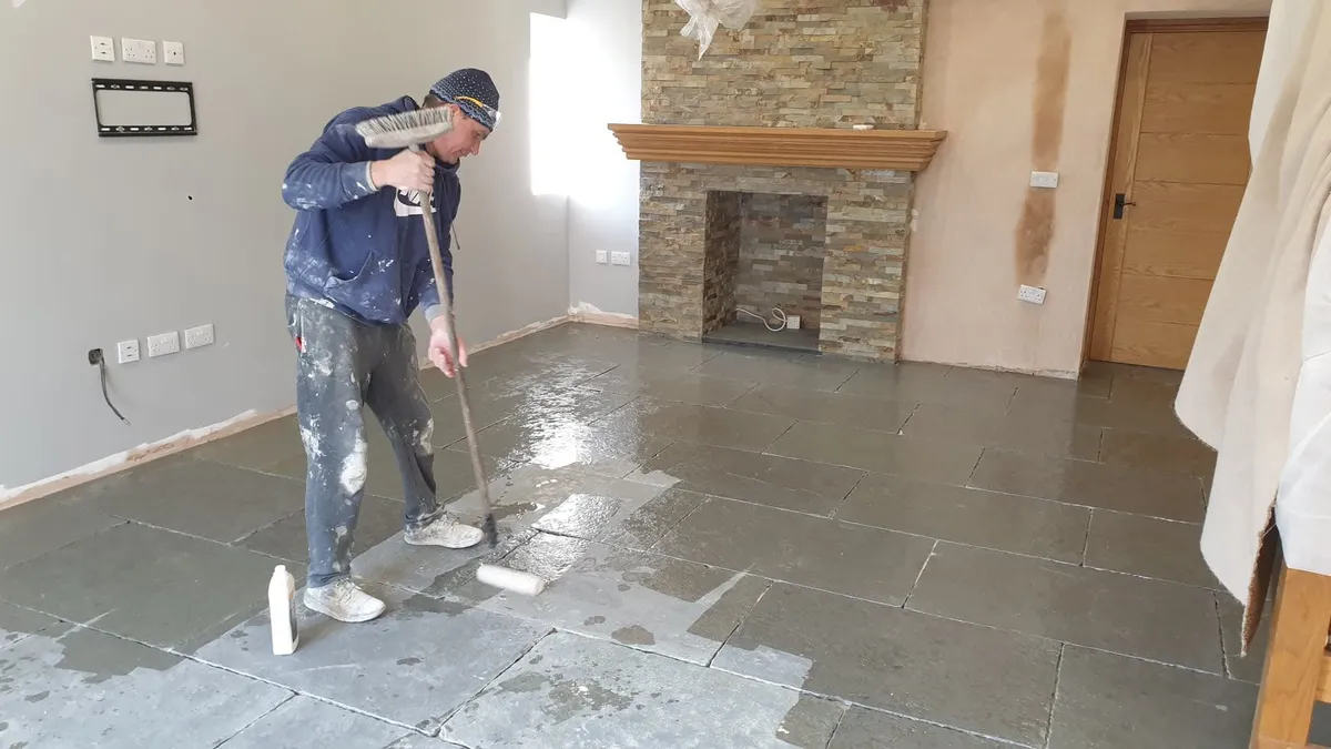 Chris cleaning and sealing a natural stone floor in a Swansea living room