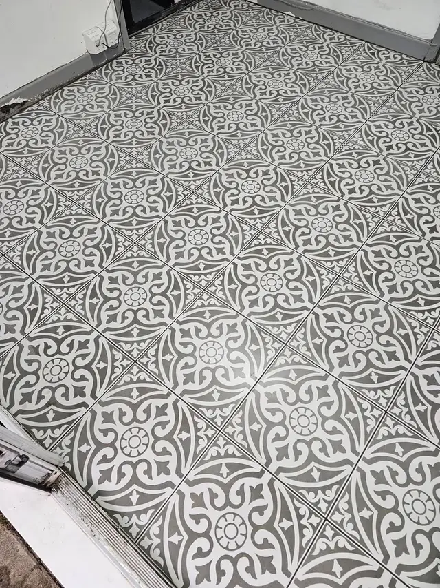 Black and white patterned floor tiles laid in a Swansea home