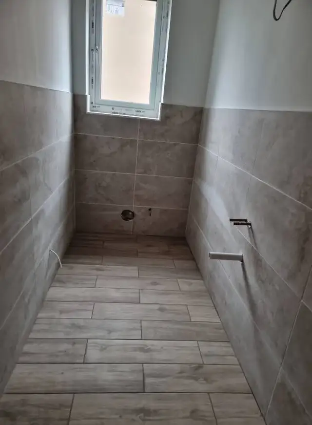 Bathroom tiling in Swansea: half brownish floor