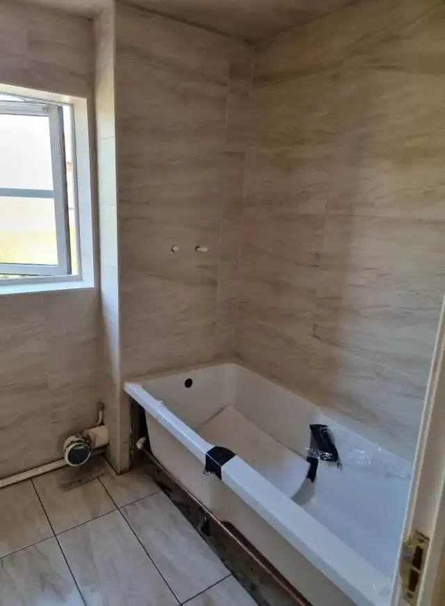 Bathroom tiling in Swansea: beige tile white grout